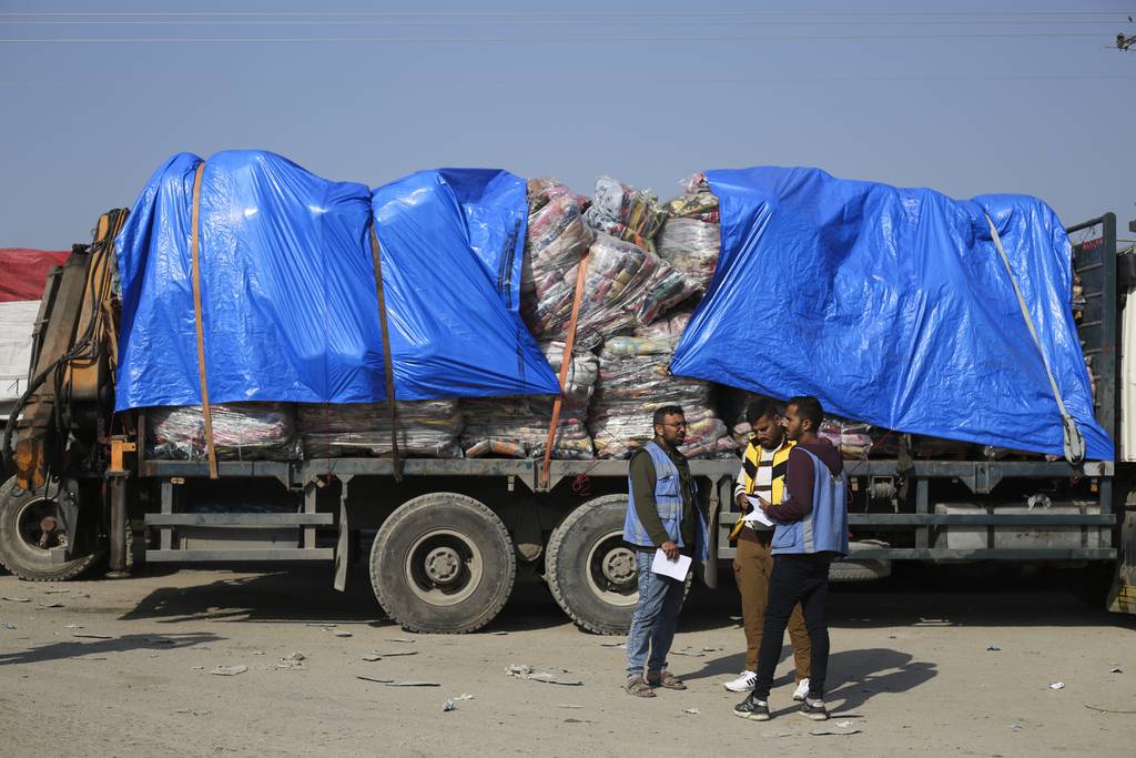 Humanitarian aid trucks enter through the Kerem Shalom crossing from Israel into the Gaza Strip on Monday, Dec. 18, 2023.